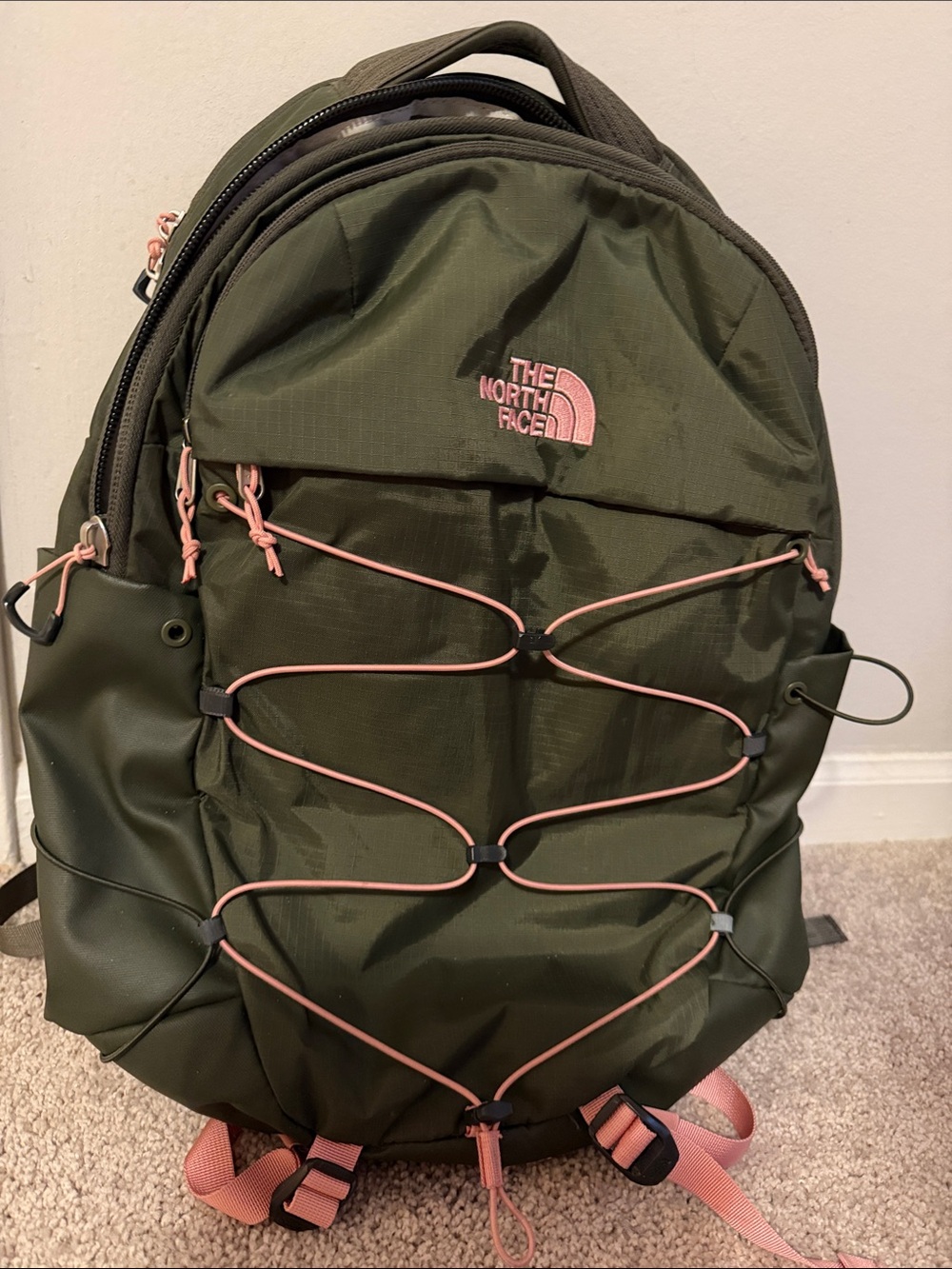 The North Face Olive Green Backpack with Pink Accents and Bungee Front